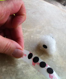 Rolled up tabe put on cotton ball to stick paper electrons to.  Only two pieces!